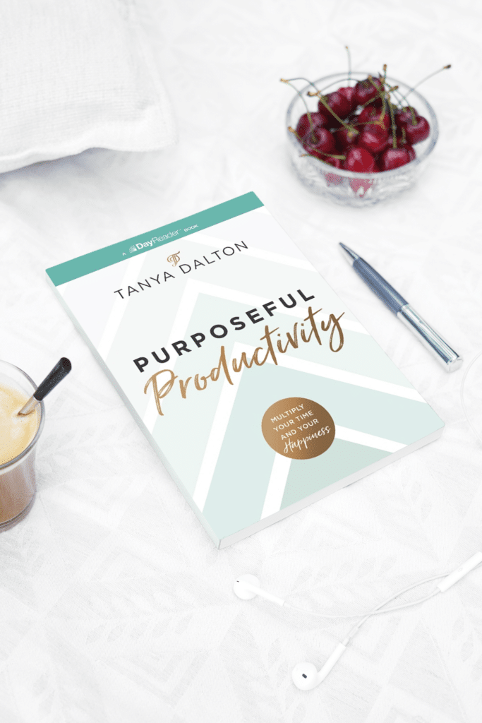 Book on productivity for women next to a bowl of cherries